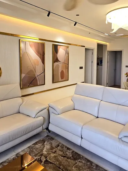 Here is an example of how custom art can complete a living room. This diptych, featuring flowing abstract forms in an earthy palette, was designed to complement the room's elegant decor and warm lighting.