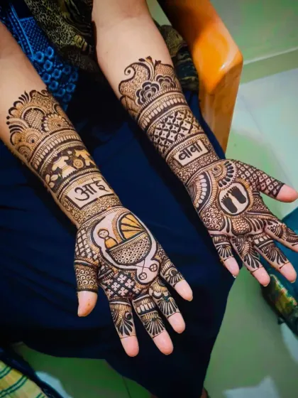 A slightly different angle of the "Aai-Baba" baby shower design, showing the full forearm coverage and intricate fill patterns.