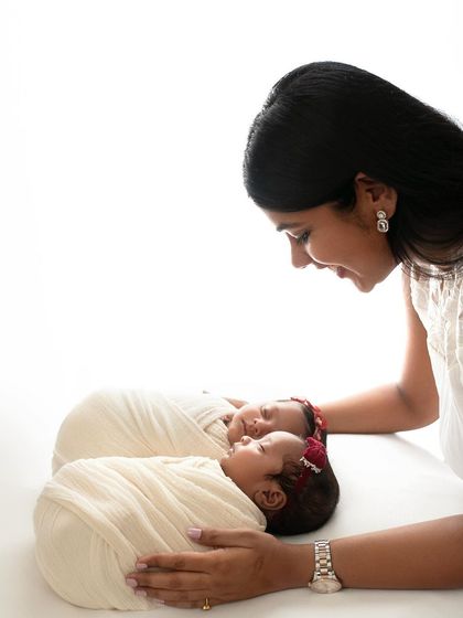 A mother looking down at her sleeping twins. The simplicity of the white background keeps all the focus on her love and their peacefulness.