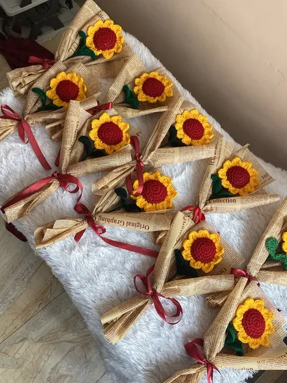 A look at a bulk order of single stem sunflowers, all individually wrapped in newspaper. These are perfect as return gifts or for events like Teacher's Day.