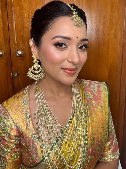 A portrait of grace. The complete look showcases how the makeup, hair, and stunning jewelry come together for a truly timeless South Indian bridal aesthetic.