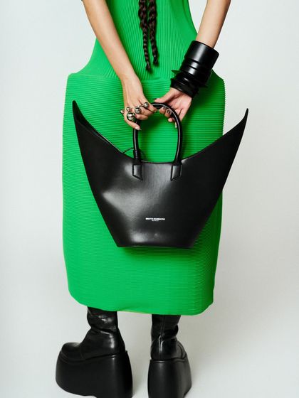 A full look from the ground up, showing the dramatic platform shoes that anchored the entire sculptural outfit.