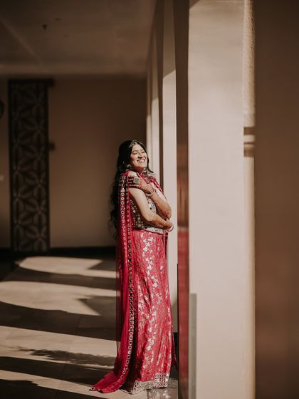A candid moment of laughter in the sun. I love capturing the bride's natural joy, and the warm light filtering through the arches makes this shot feel spontaneous and full of life.