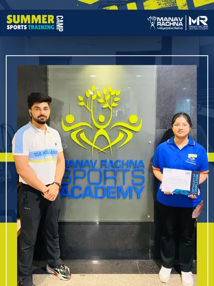 A participant and a coach pose with the certificate of completion. The camp concludes with a ceremony to recognize the dedication and achievements of our young athletes.