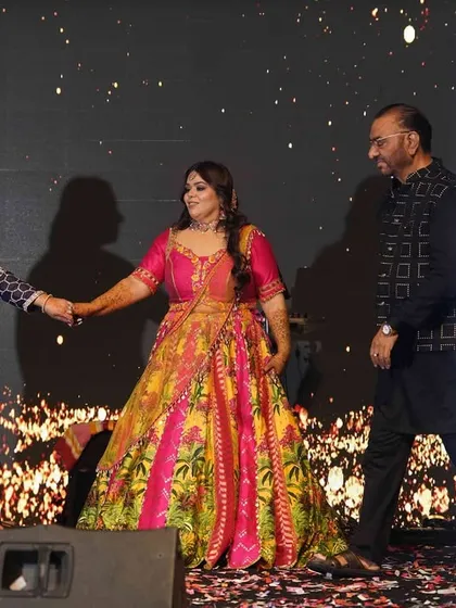 A family trio performing together on stage. We love creating choreographies that bring different family members together for a memorable performance.