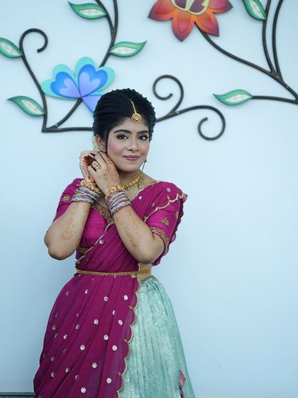 Nothing makes me happier than dressing sisters for their special moments. I designed these matching turquoise and purple Langa Voni outfits for a half saree function, ensuring they both looked coordinated yet unique.