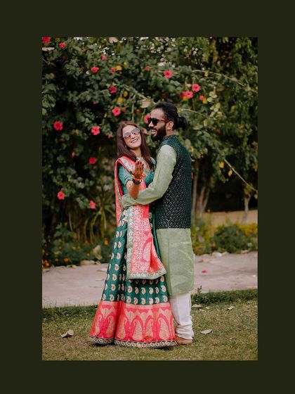 A fun, candid moment from the Mehendi in Orchha. The bride's bright smile and sunglasses add a touch of modern fun to the traditional ceremony.