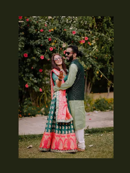 A fun, candid moment from the Mehendi in Orchha. The bride's bright smile and sunglasses add a touch of modern fun to the traditional ceremony.