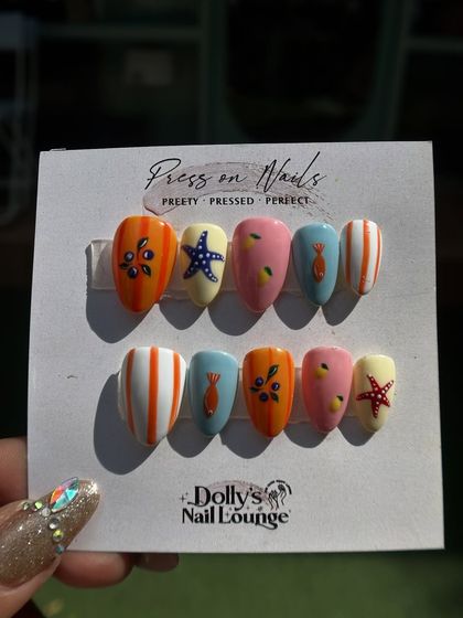 A fun, summery press-on set with a beach theme, including hand-painted starfish, fish, and colorful stripes.
