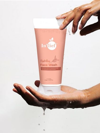 A refreshing shot of In'lief face wash with hands creating a lather. Using water and foam helps convey the product's cleansing properties and creates a feeling of freshness.