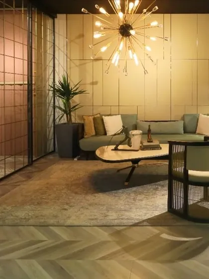 A view of our contemporary lounge space from the AD Design Show. The setting combines a pastel green sofa with chairs featuring woven metal bases, demonstrating our ability to create cozy yet design-forward environments.