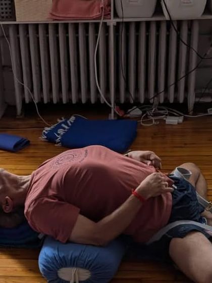 A restorative pose, Supta Virasana, on a bolster.