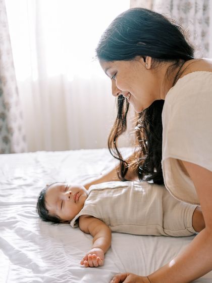 A mother watching over her sleeping baby in the soft morning light. These quiet, unposed moments are often the most powerful.