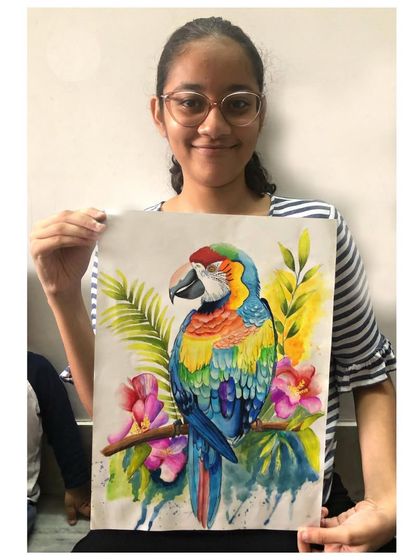 A student with her stunningly realistic watercolour painting of a macaw. We work on advanced techniques to capture the bird's colourful plumage.