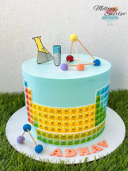 For a young science enthusiast, we made this periodic table cake. The design features an edible print of the periodic table wrapped around the cake, with fondant molecules on top.