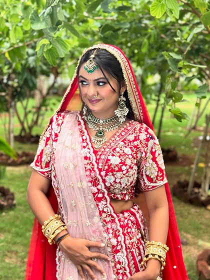 This three-quarter shot shows how the dupatta is draped to complement the intricate embroidery of the lehenga, completing the royal bridal look.