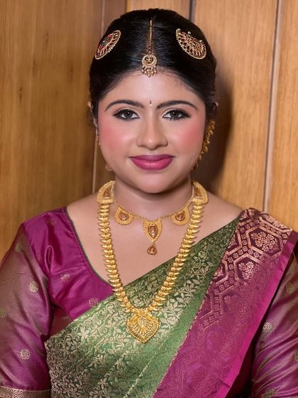 A close-up of Mayuri's bridal makeup. The defined eyes and bright lip color are balanced to create a look that is both traditional and radiant.