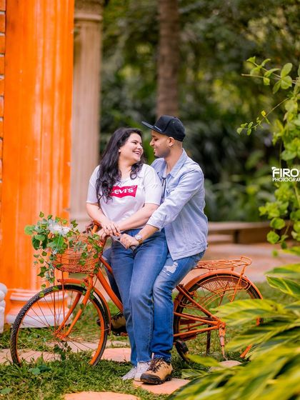 A fun and casual shot with a bicycle against a colorful building in the garden.