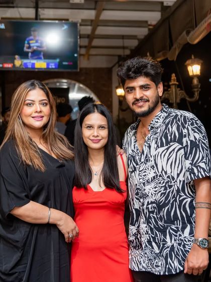 A group of friends gathered for a night of fun. The live match on the overhead screen is part of the lively ambiance I cultivate, blending a social hangout with a sports bar experience.