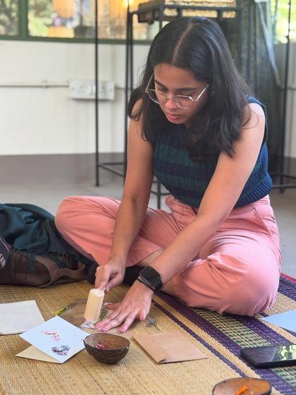 Deep in the creative zone, this participant is carefully pounding her floral design. The process requires a gentle touch and patience, making it a very mindful and relaxing art form.