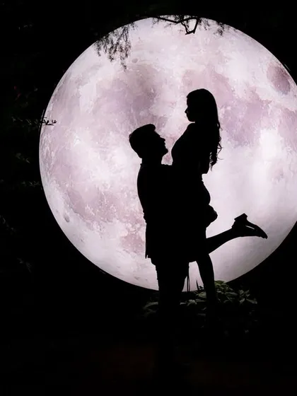 The giant moon prop is a fantastic tool for creating dramatic and artistic silhouette shots. It adds a touch of cosmic wonder to your night-time couple photography.