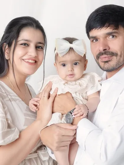 A classic portrait of a new family. Holding your baby together for one of your first family photos is a moment you'll never forget.