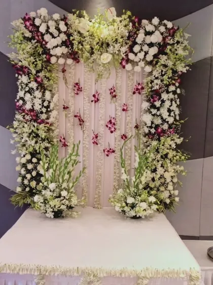 This luxurious fresh flower mandap uses a combination of white roses, gladiolus, and exotic purple orchids for a truly sophisticated and grand statement.