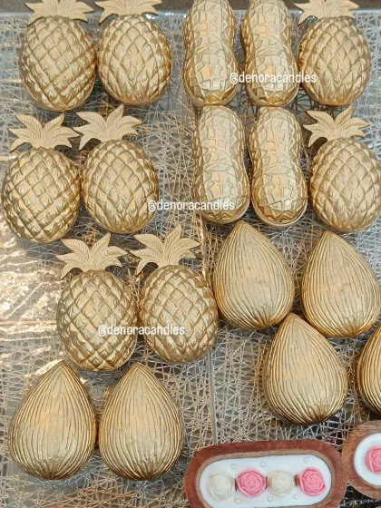 A collection of my golden pineapple, peanut, and coconut urli candles, prepared for a large festive order.