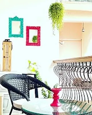 This is the second, cozier balcony nook attached to the Green Room. The wicker chair and small table create an intimate corner, perfect for reading a book or simply enjoying a quiet moment.
