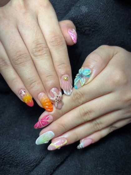 A playful and colorful set featuring a variety of 3D elements, including an octopus, flowers, and different textures on each nail.