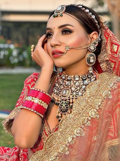 A bride's glow is her best accessory. This classic red bridal look, shot outdoors, shows how makeup can look stunning in natural light.