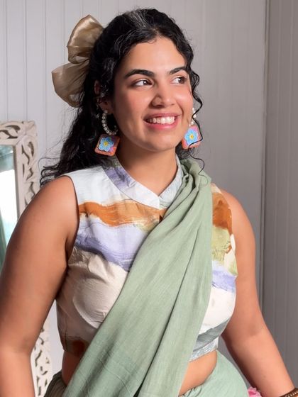 Another outtake from the Dressfolk shoot. Here I've paired a printed sleeveless blouse with a solid saree, adding a big bow to my hair for a playful, modern-ethnic look.