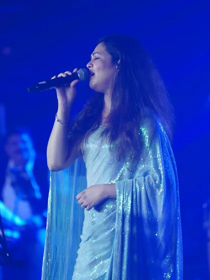 Priyanka Barve performing on stage in the glittering silver saree.