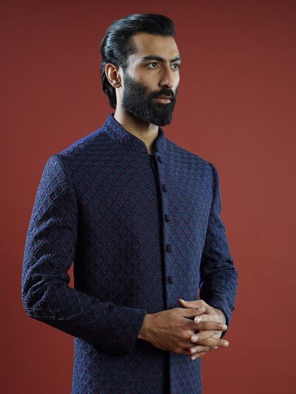 A closer look at a navy blue Bandhgala, detailed with fine Cut Dana and thread embroidery. This piece is an ideal look for a Sagan or engagement ceremony, balancing tradition with a sharp, modern cut.