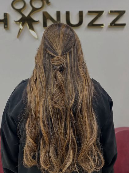 A cute half-up hairstyle to show off the different tones in her light brown and blonde hair.