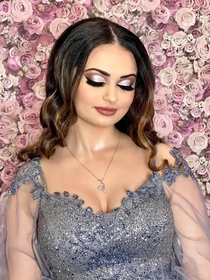 A glamorous reception look perfect for a winter wedding. I created a dramatic silver glitter eye with a sharp wing and paired it with a matte nude lip. The skin is airbrushed to perfection for a look that stuns in person and on camera.