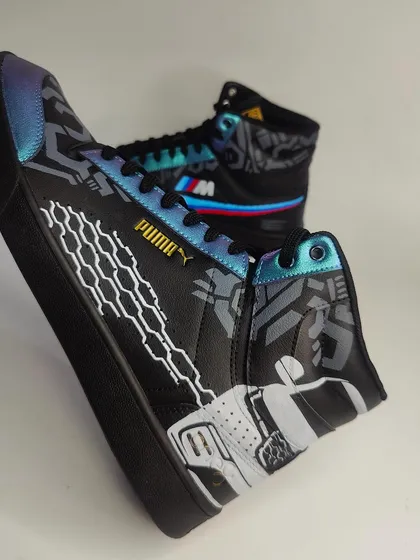 The design also includes illustrations of the cars themselves on the outside of the sneaker, making it a complete tribute to the client's favourite machines.