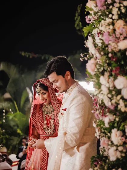 For Sakshi and Shuvam's wedding, we created this opulent mandap under the stars. The structure was completely covered in lush pink, peach, and white florals, with a soft fabric canopy and a chandelier for a touch of timeless elegance.