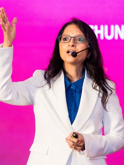 Speaking on stage in a white suit. I am on a mission to make India the Author Capital of the World by empowering one million people to rise through their stories.