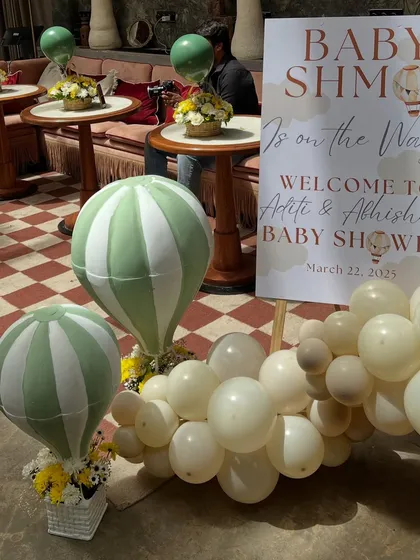 The entrance decor in action, with guests arriving to the beautiful welcome sign and themed hot air balloon props.