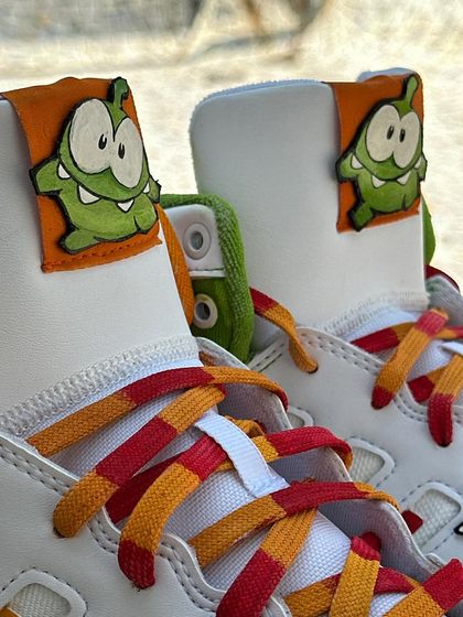 A close up of the tongue detail on the "Cut the Rope" sneakers, where I painted Om Nom on a separate leather patch to give it a 3D look.