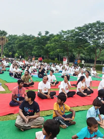 Children and adults practicing together in the park, showing that yoga is truly for everyone.