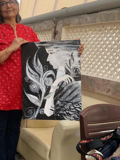 Holding the finished black and white portrait. The stark contrast and flowing lines were chosen to create a piece that is both visually and emotionally impactful.