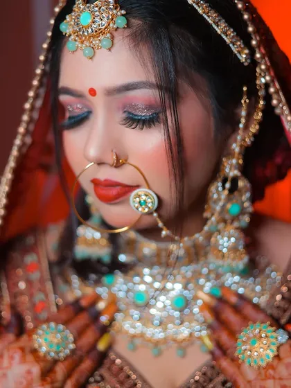 A detailed close-up of the bride's makeup, focusing on the glittery eyeshadow and bold red lips.