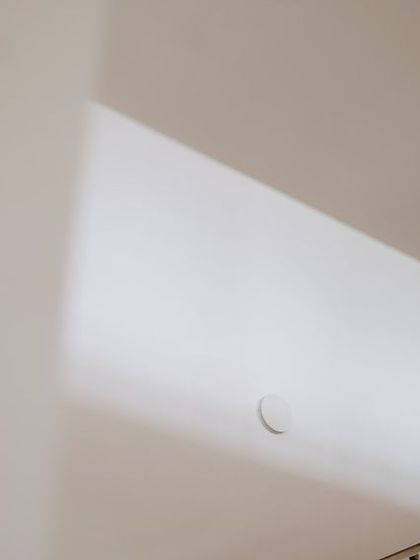 An artistic and minimalist shot of a couple on a staircase, using negative space to create a unique composition.