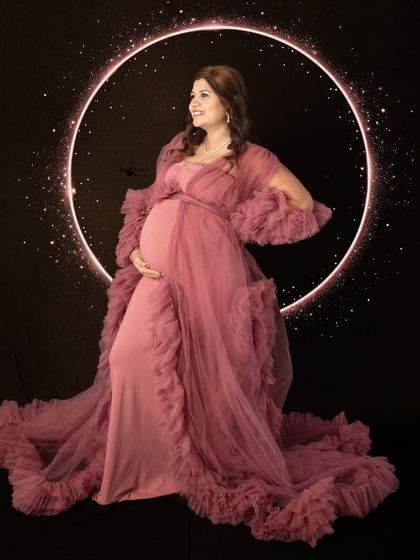 Framed by a ring of light, this mother-to-be shines in a dramatic pink gown. This setup is one of my favorites for creating a truly magical and ethereal maternity portrait.