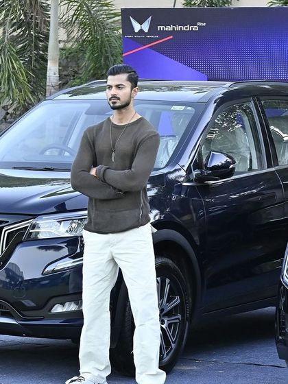 A full shot of the Mahindra XUV700, with me as the model adding a human and fashion-forward element to the campaign.