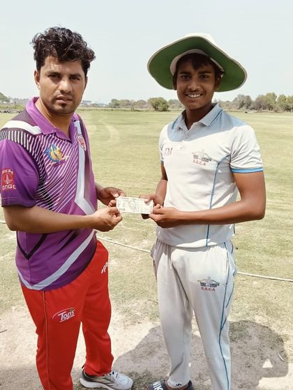 Tarun Garg receiving a cash prize for being the Man of the Match. His contribution with both bat and ball was vital.