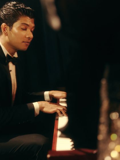 The pianist, lost in his music. This quiet, focused shot adds depth and texture to the overall atmosphere of the jazz club scene for Origin & Ode.
