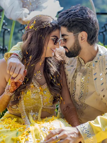 An intimate moment amidst the flower petals. Even with all the fun and games, we find the quiet instances of connection that make a Haldi ceremony so special.